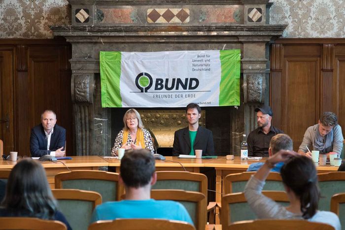 Ein Podium, davor Publikum